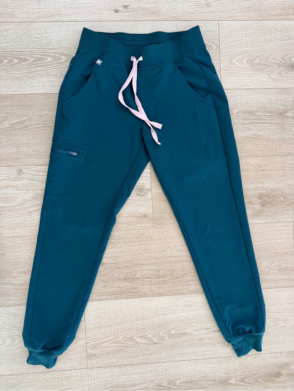 FIGs Zamora jogger scrub pants in a teal blue color